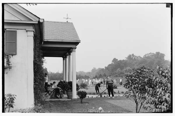 Children's House and Garden.
View from Formal Garden, children at work.  1923
