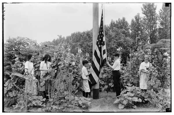Formal Garden.  Flag raising.
Hollyhocks, tying and staking of, by students.  1923.