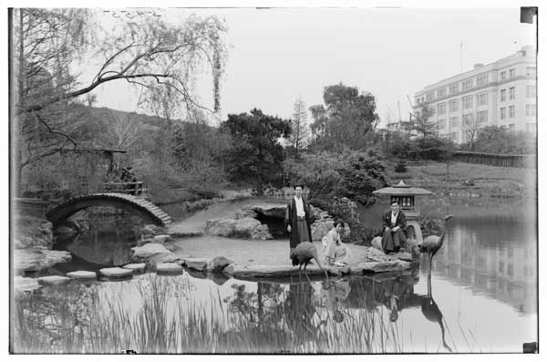 Japanese garden.  
View from W. shore. Three natives in costume posing on island-1925.