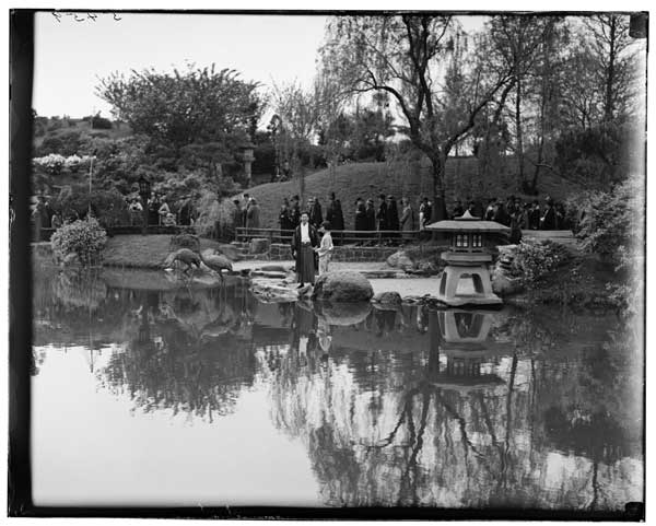 Japanese Garden.
Three people in costume at temple gate.