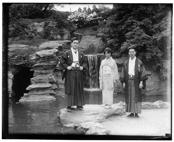 Japanese Garden.
Three people in costume at temple gate.